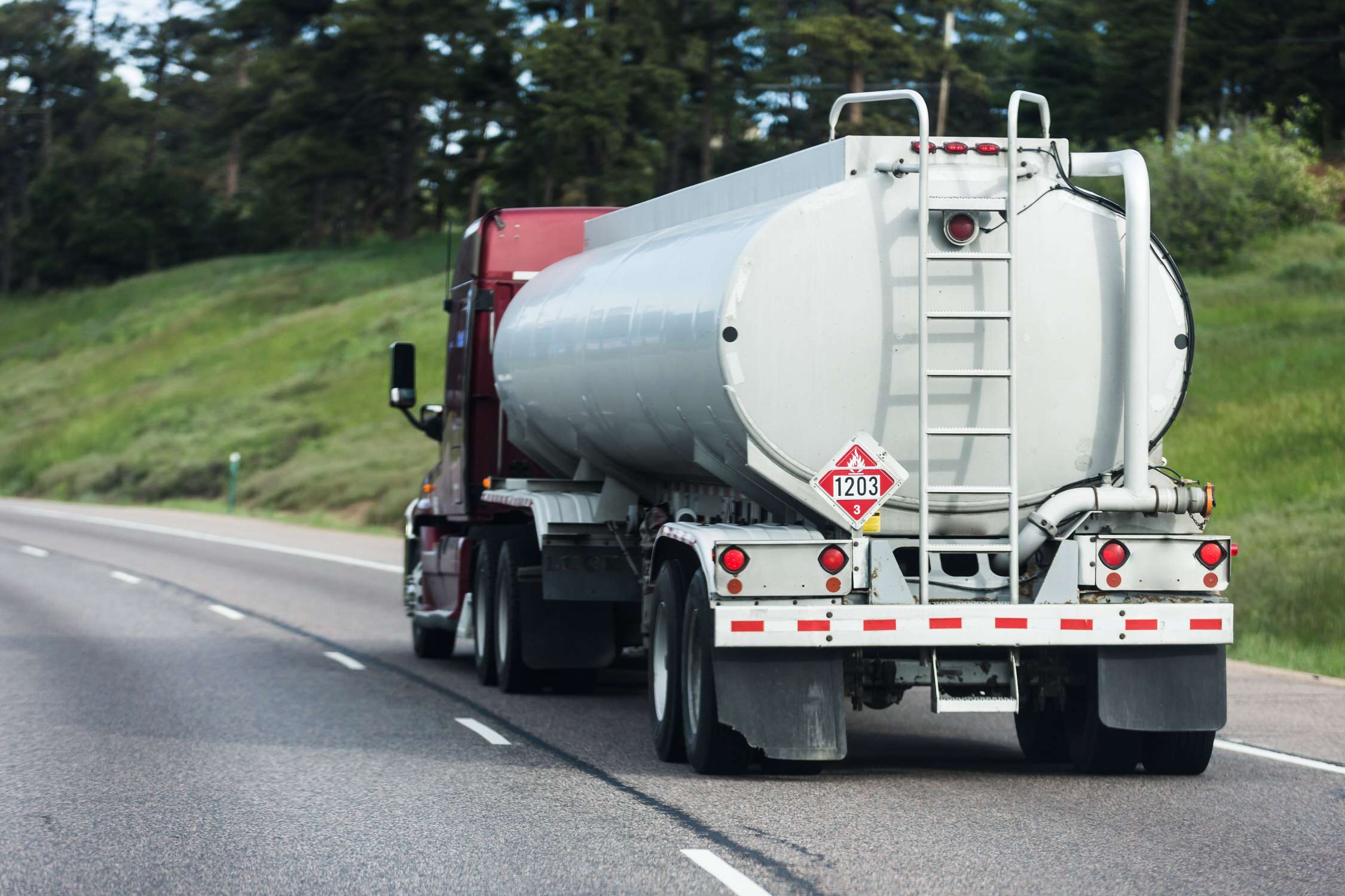 Large tanker truck hauling on highway