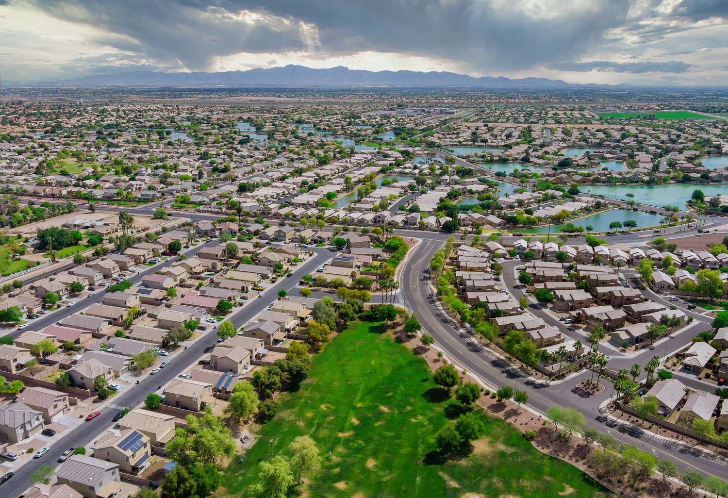 Aerial roofs of the many small ponds near a Avondale town houses in the urban landscape of a small sleeping area Phoenix Arizona US