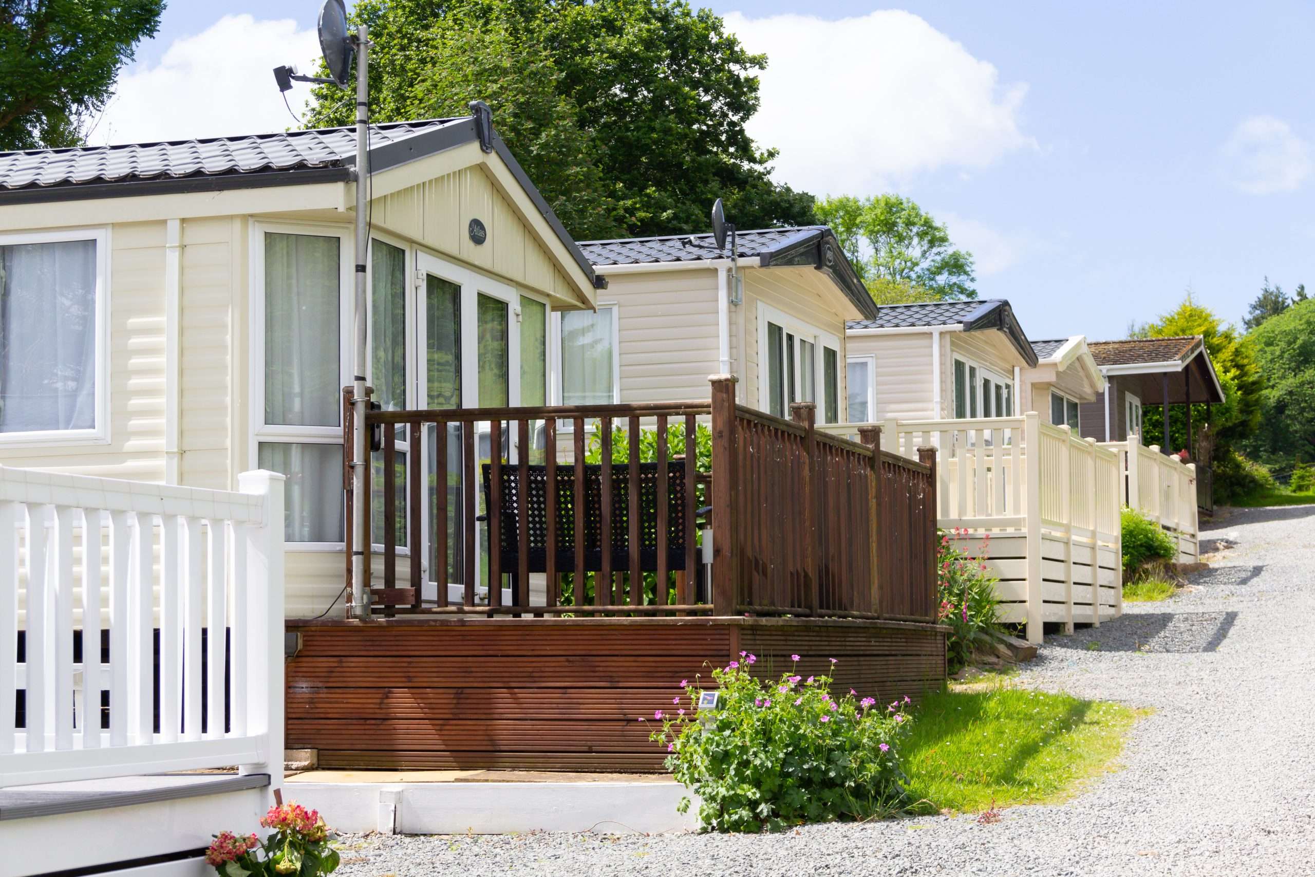 Row of static mobile homes on caravan site in rural Wales, places where people come to relax and vacation away from the stresses of the world.