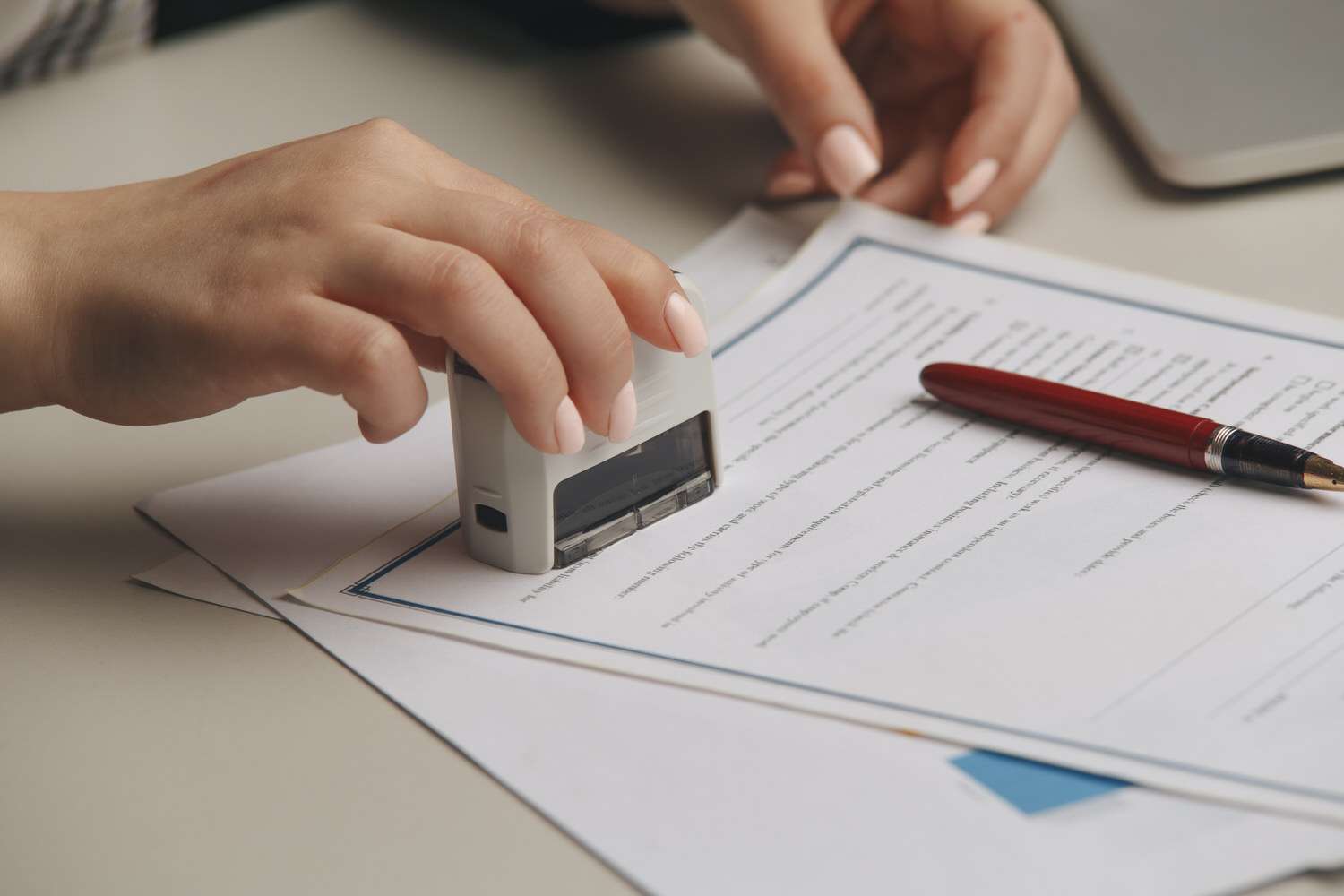 Close up on woman's notary public hand stamping the document. Notary public concept