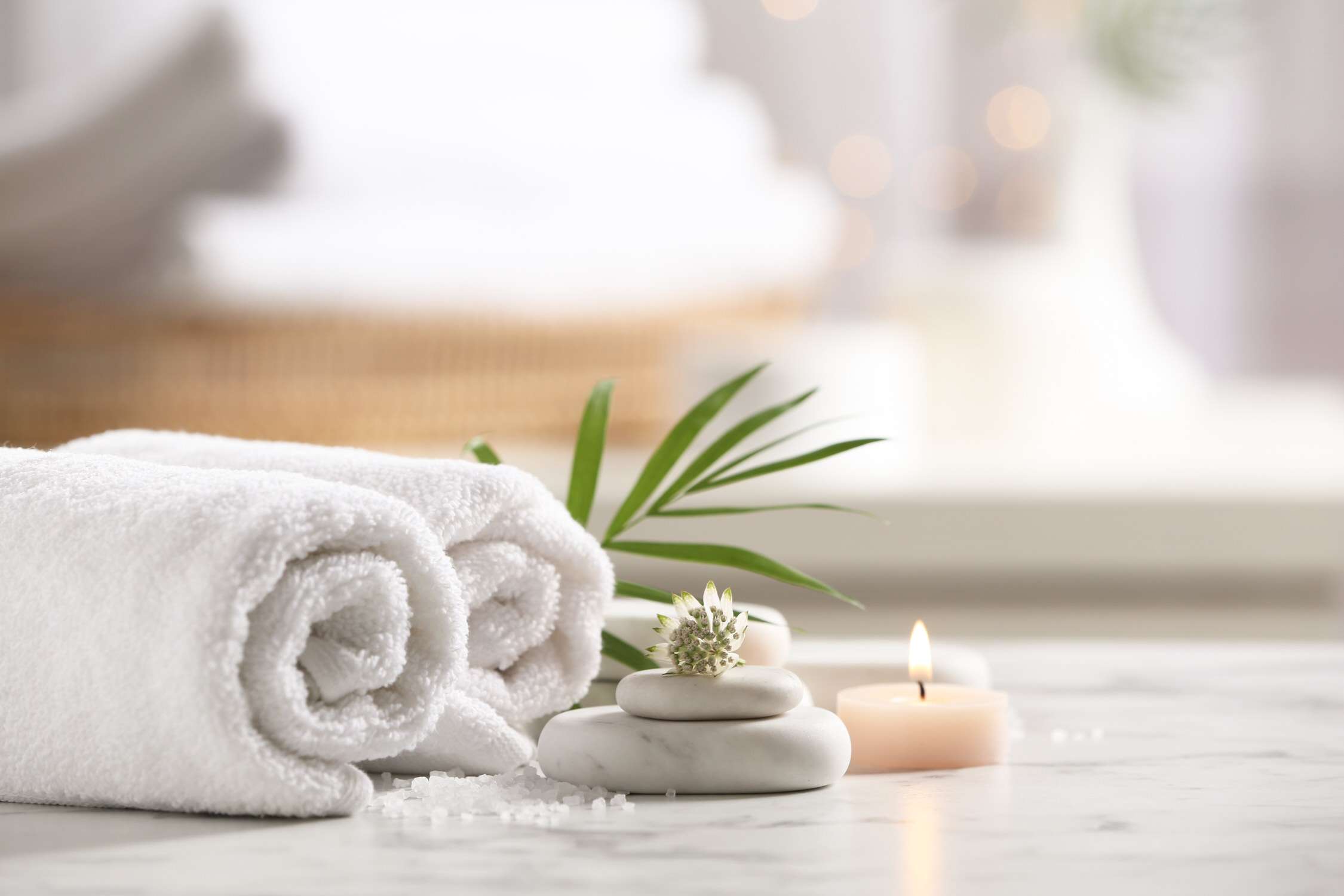 Beautiful composition with spa stones on white marble table