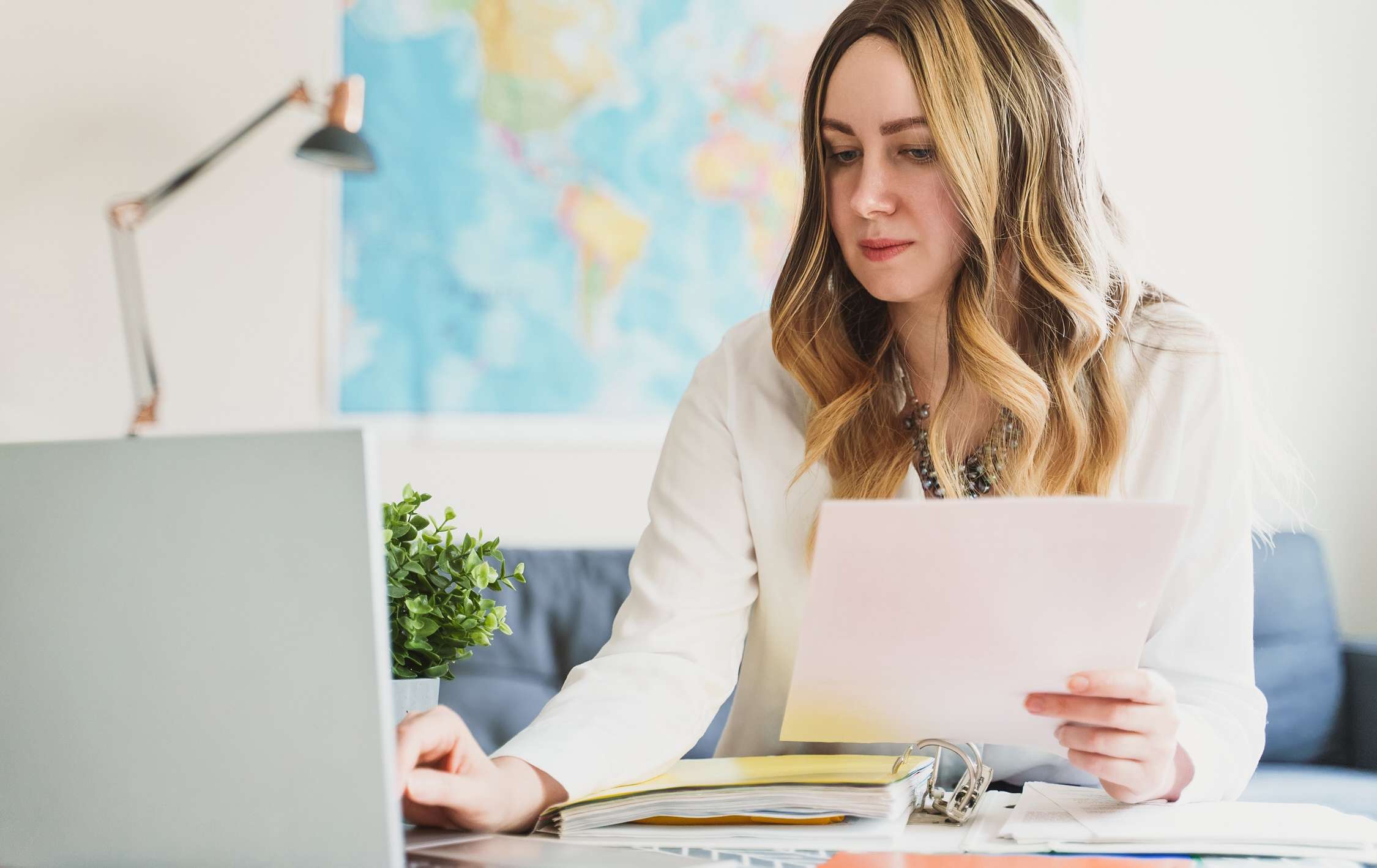 Travel agent working with documents at office.